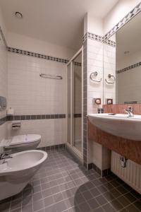 a bathroom with two sinks and a shower at Hotel Kinsky Fountain in Prague