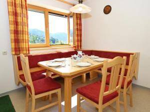 a dining room with a table and chairs and a window at Large Apartment in Maria Alm with Terrace in Maria Alm am Steinernen Meer