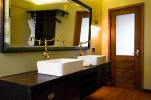 ein Badezimmer mit zwei Waschbecken und einem großen Spiegel in der Unterkunft Fuvahmulah Central Hotel in Fuvahmulah
