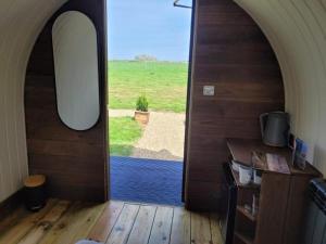 a room with a door with a view of a field at Piglet 2 in Yarmouth