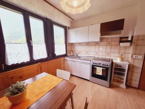 a kitchen with a table and a stove top oven at Apartma Ferjan in Žaga