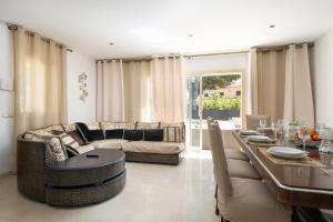 a living room with a couch and a table at Villa Isabella - Ideal Property Mallorca in Muro