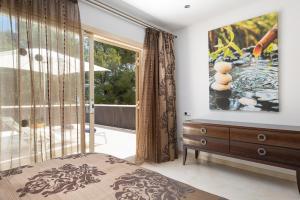 a bedroom with a bed and a large window at Villa Isabella - Ideal Property Mallorca in Muro