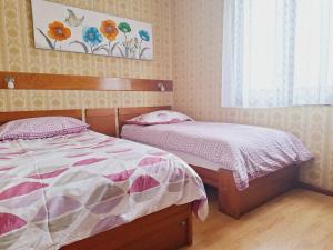 a bedroom with two beds and a window at Apartma Ferjan in Žaga