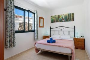 a bedroom with a bed and a large window at Apartamentos Bella Vista in Puerto del Carmen