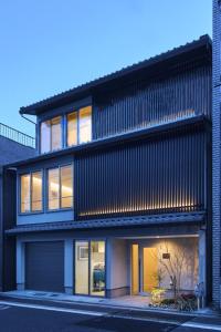 a house with a black facade with windows at ホテルトーイン京都 in Kyoto