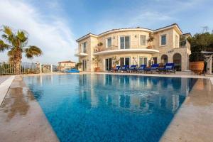 a large swimming pool in front of a house at Bella Vista, Kaş Antalya in Kaş
