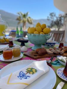 a table topped with plates and a bowl of lemons at Bella Vista, Kaş Antalya in Kaş