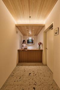 a woman standing at a reception desk in a hotel room at ホテルトーイン京都 in Kyoto