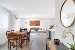 a dining room and living room with a table and chairs at Beautiful Balmain Abode - Balmain, NSW in Sydney