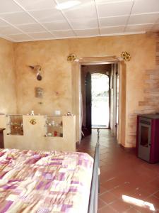 een slaapkamer met een bed en een hal met een deuropening bij 2 bedrooms house with sea view furnished terrace and wifi at Castelmola 5 km away from the beach in Castelmola