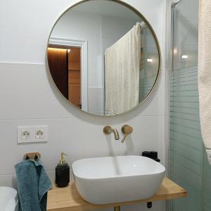 a bathroom with a white sink and a mirror at Curota A in Ribeira