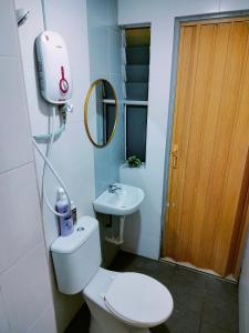 a small bathroom with a toilet and a sink at Idea Homestay 1 in Chemor