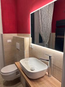 a bathroom with a sink and a toilet and a mirror at Villa delle mimose in Sestri Levante