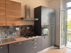 a kitchen with stainless steel cabinets and a stove at Villa delle mimose in Sestri Levante