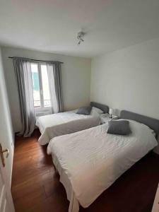 a bedroom with two beds and a window at Beautiful apartment - Centre in Cagnes-sur-Mer