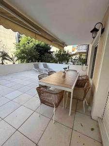 a wooden table and chairs on a patio at Beautiful apartment - Centre in Cagnes-sur-Mer +2 photos
