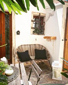 a patio with a bench and a window at Bouganville in Rosignano Marittimo