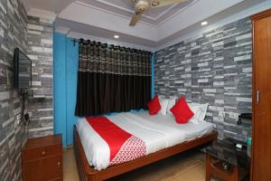 um quarto com uma cama com almofadas vermelhas em OYO A G Residency & Son em Bumlitan