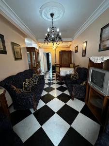 a living room with a black and white checkered floor at Bel appartement meublé à louer in Fort de lʼEau