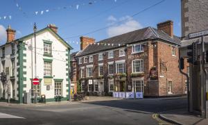 a group of buildings on a city street at The Royal Oak Hotel, Welshpool, Mid Wales in Welshpool