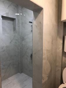 a shower with a glass door in a bathroom at Rejhan TOTTI in Ulcinj +43 photos