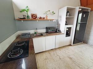 a small kitchen with a stove and a sink at Villa Harmony - Residence in Seminyak
