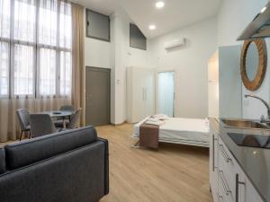 um quarto com uma cama e uma cozinha com um lavatório em Apartamentos La Fuensanta em Córdoba