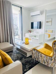 a living room with a couch and a table at Waterfall Peaceful Oyster in Midrand