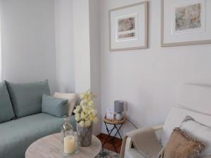 a living room with a couch and a table at Solerma in Viveiro