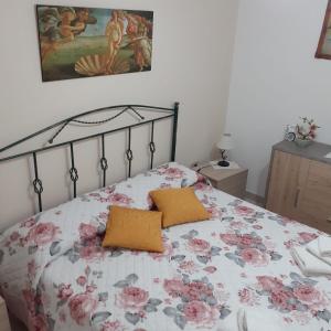 een slaapkamer met een bed met een bloemenbed bij villino scianuli in Torre Squillace