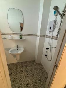 a small bathroom with a sink and a mirror at La Locanda in Bangkok