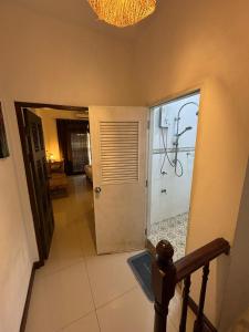 a hallway with a door leading to a room with a bathroom at La Locanda in Bangkok