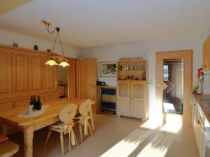 a kitchen with a wooden table and a dining room at Comfort apartment with balcony in the beautiful Bavarian Forest in Drachselsried