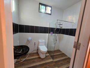 a bathroom with a shower and a toilet and a sink at Riverhilk khaoyai in Ban Bung Toei