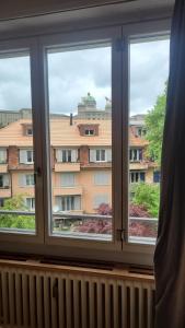 a window with a view of a building at Room in Marzili in Bern