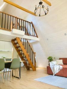 a staircase in a living room with a table and chairs at Rural Retreat Transylvania in Gura Rîului