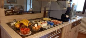 a kitchen counter with a tray of fruits and vegetables at Agritur Arcosole B&B Camping in Arco