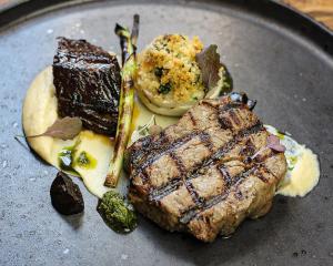 a plate of food with a steak and a dessert at Jasper's a cosy comfortable 4 bedroom house in Meir close to Trentham Gardens in Stoke on Trent