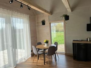 a dining room with a table and chairs and a window at Holiday home Filipi 