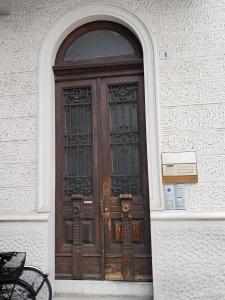 a wooden door on a building with a sign in front at King store in Udine