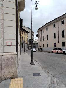 a street light on the side of a city street at King store in Udine