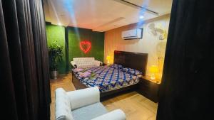 a bedroom with a bed and a heart on the wall at Luxury Private Top Floor Apartment in Heart of Bahria Town in Lahore