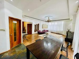 a living room with a wooden table and a couch at Five seasons guest house in Ulaanbaatar