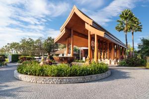 a building with a fountain in front of it at Aquella Lakeside Villas in Thai Muang