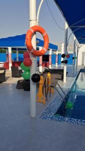 a swimming pool with a life preserver on a cruise ship at Sharjah International Airport Hotel in Sharjah