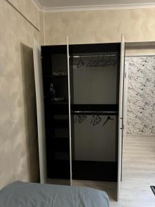 a bedroom with a sliding glass door to a closet at Apartment in Airport in (( Turksib ))