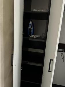 a closet with a black and white shelf at Apartment in Airport in (( Turksib ))
