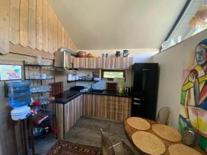 a kitchen with a table and a refrigerator at Charmante Ruheoase am Meer in Lettland in Miķeļtornis +14 photos