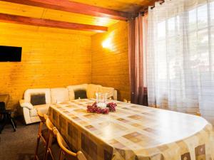 a dining room with a table and a couch at Modern Holiday Home in Cern Dul with Private Garden in Černý Dŭl